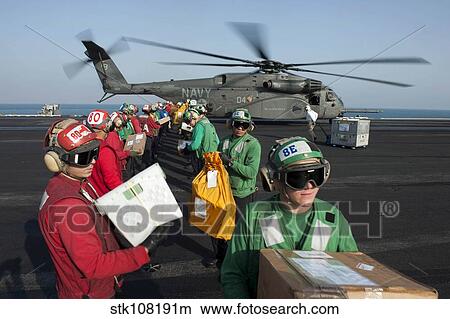 Picture - Sailors unload mail from an MH-53E Sea Dragon.. Fotosearch