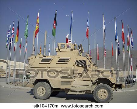 Picture - Santa tosses candy from a MaxxPro Mine Resistant Ambush Protected vehicle.. Fotosearch
