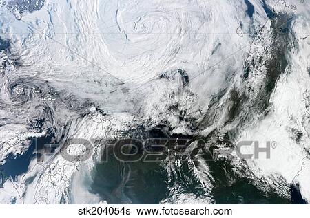 Satellite view of large and powerful cyclone churning over the Arctic. View Large Photo Image Stock Photograph - Satellite view of large and powerful cyclone churning over the Arctic.. Fotosearch