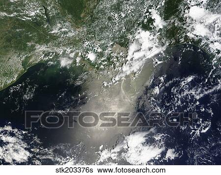 Stock Photograph - Satellite view of streaks and ribbons of oil brighten the reflection of the Sun off the Gulf of Mexico.. Fotosearch