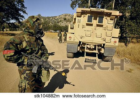 Picture - Seabees conduct a wash down of a suspicious vehicle.. Fotosearch