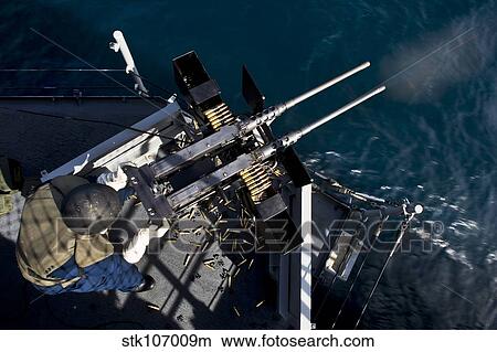 Seaman fires twin. 50 caliber machine guns aboard USS Boxer. View Large Photo Image Picture - Seaman fires twin. 50 caliber machine guns aboard USS Boxer.. Fotosearch