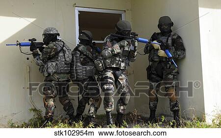 Picture - Security Forces members perform a quick check before entering a house.. Fotosearch