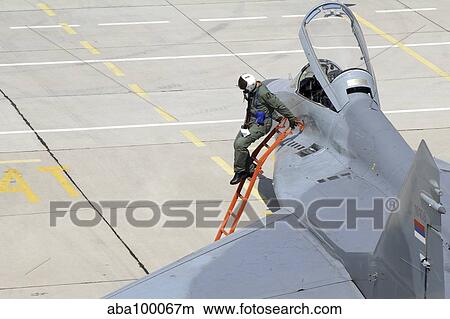 Serbian Air Force pilot climbs down from the cockpit of a MiG-29. View Large Photo Image Picture - Serbian Air Force pilot climbs down from the cockpit of a MiG-29.. Fotosearch