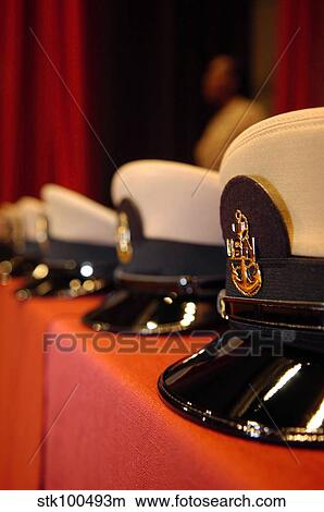 Several chief petty officers combination covers lined up on a table. View Large Photo Image Picture - Several chief petty officers combination covers lined up on a table.. Fotosearch