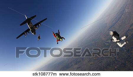 Picture - Several military freefall parachutist course students exit an aircraft.. Fotosearch