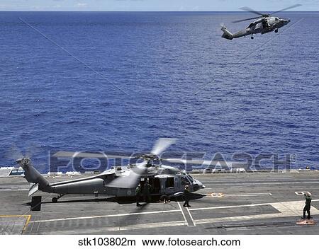 SH-60 Sea Hawk helicopters land aboard the aircraft carrier USS Ronald Reagan. View Large Photo Image Picture - SH-60 Sea Hawk helicopters land aboard the aircraft carrier USS Ronald Reagan.. Fotosearch