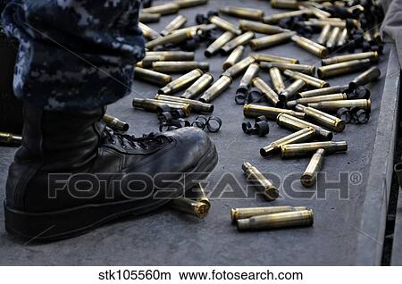 Shell casings from a. 50 caliber machine gun around the feet of a soldier. View Large Photo Image Picture - Shell casings from a. 50 caliber machine gun around the feet of a soldier.. Fotosearch