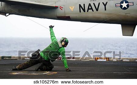 Shooter signals for the launching of an EA-6B Prowler. View Large Photo Image Picture - Shooter signals for the launching of an EA-6B Prowler.. Fotosearch
