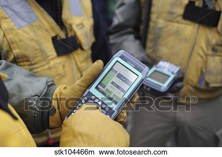 Picture - Shooters test a catapult capacity selector valve calculator during flight operations.. Fotosearch