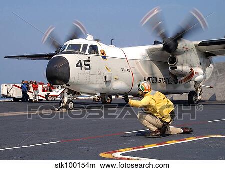 Signalman gives the launch signal to a C-2A Greyhound. View Large Photo Image Picture - Signalman gives the launch signal to a C-2A Greyhound.. Fotosearch