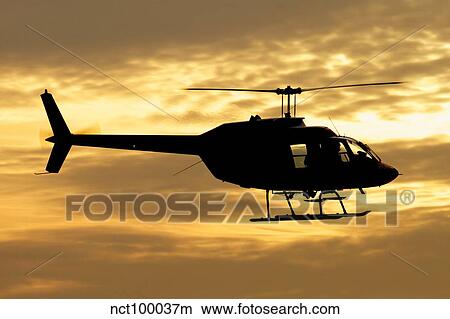 Picture - Silhouette of a Bell 206 utility helicopter.. Fotosearch