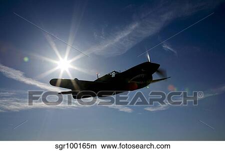 Silhouette of a Curtiss P-40E Warhawk in flight near Chino, California. View Large Photo Image Picture - Silhouette of a Curtiss P-40E Warhawk in flight near Chino, California.. Fotosearch