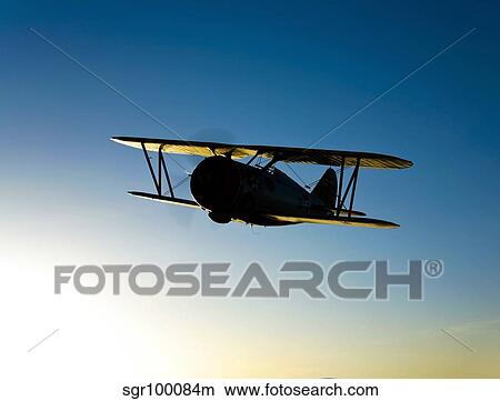 Silhouette of a Grumman F3F biplane in flight. View Large Photo Image Picture - Silhouette of a Grumman F3F biplane in flight.. Fotosearch
