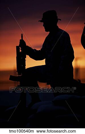 Silhouette of a U. S Marine on a bunker at sunset in Afghanistan. View Large Photo Image Picture - Silhouette of a U. S Marine on a bunker at sunset in Afghanistan.. Fotosearch