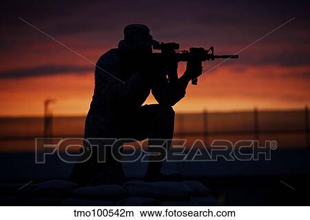 Silhouette of a U. S Marine on a bunker at sunset in Afghanistan. View Large Photo Image Picture - Silhouette of a U. S Marine on a bunker at sunset in Afghanistan.. Fotosearch