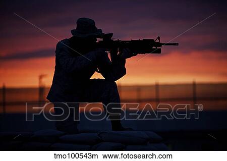 Silhouette of a U. S Marine on a bunker at sunset in Afghanistan. View Large Photo Image Picture - Silhouette of a U. S Marine on a bunker at sunset in Afghanistan.. Fotosearch
