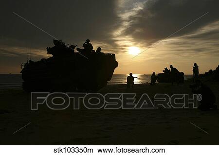 Silhouette of Marines and an amphibious assault vehicle providing security on Hwajin Beach, Republic of Korea. View Large Photo Image Picture - Silhouette of Marines and an amphibious assault vehicle providing security on Hwajin Beach, Republic of Korea.. Fotosearch