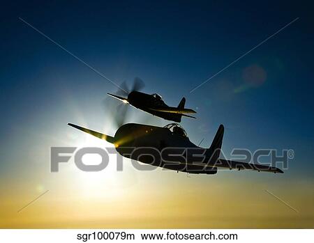 Silhouette of two Grumman F8F Bearcats in flight. View Large Photo Image Picture - Silhouette of two Grumman F8F Bearcats in flight.. Fotosearch