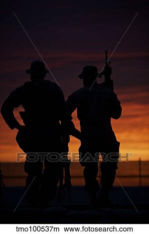 Silhouette of U. S Marines on a bunker at sunset in Afghanistan. View Large Photo Image Picture - Silhouette of U. S Marines on a bunker at sunset in Afghanistan.. Fotosearch