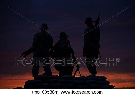 Picture - Silhouette of U. S Marines on a bunker at sunset in Afghanistan.. Fotosearch