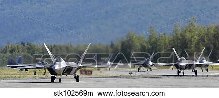 Six F-22 Raptors taxi down the runway. View Large Photo Image Picture - Six F-22 Raptors taxi down the runway.. Fotosearch