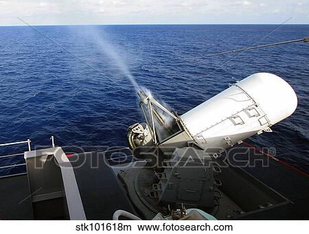 Smoke rolls down the barrels of the forward-starboard-mounted MK 15 Phalanx Close-In weapons System. View Large Photo Image Picture - Smoke rolls down the barrels of the forward-starboard-mounted MK 15 Phalanx Close-In weapons System.. Fotosearch