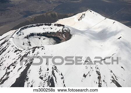 Stock Photograph - Snow-covered Ngauruhoe cone, Mount Tongariro volcano, New Zealand.. Fotosearch