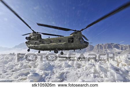 Snow flies up as a U. S. Army CH-47 Chinook helicopter prepares to land. View Large Photo Image Picture - Snow flies up as a U. S. Army CH-47 Chinook helicopter prepares to land.. Fotosearch
