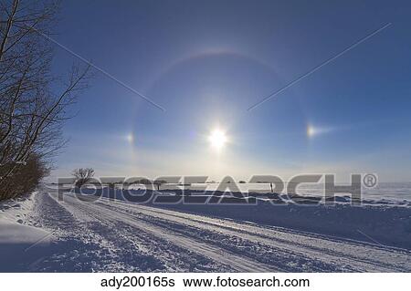 Stock Photograph - Solar halo and sundogs in southern Alberta, Canada.. Fotosearch