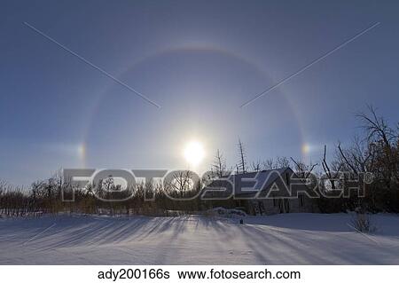 Stock Photograph - Solar halo and sundogs in southern Alberta, Canada.. Fotosearch