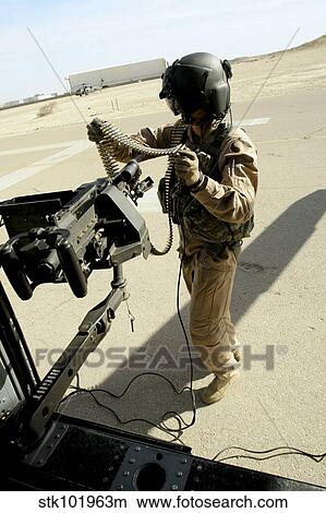 Picture - Soldier carries 7. 62 mm rounds to a M240G medium machine gun.. Fotosearch