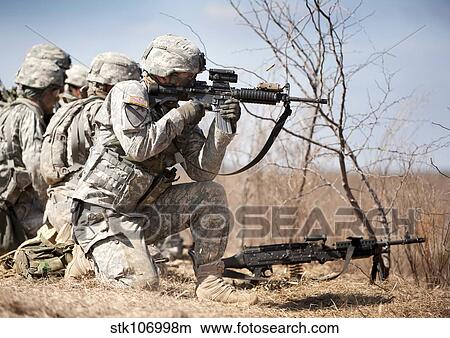 Soldier fires his rifle at a target. View Large Photo Image Picture - Soldier fires his rifle at a target.. Fotosearch
