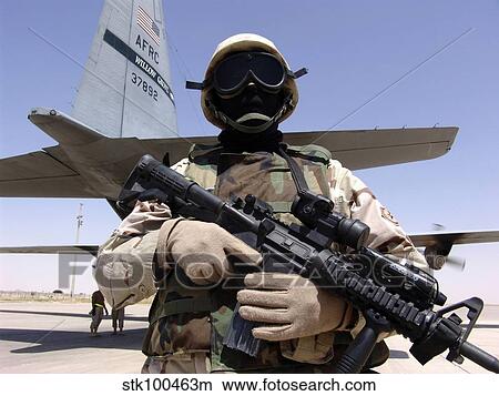 Soldier guards a C-130 Hercules and crew. View Large Photo Image Picture - Soldier guards a C-130 Hercules and crew.. Fotosearch