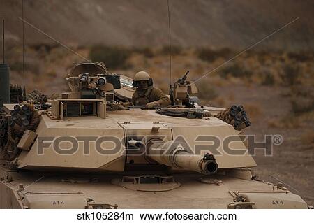 Soldier looks out the main hatch of his tank during a patrol. View Large Photo Image Picture - Soldier looks out the main hatch of his tank during a patrol.. Fotosearch