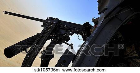 Picture - Soldier mans the. 50 caliber machine gun on a HH-60G Pave Hawk.. Fotosearch