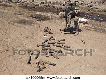 Soldier moves 82mm mortars to a safer place for demolition. View Large Photo Image Picture - Soldier moves 82mm mortars to a safer place for demolition.. Fotosearch