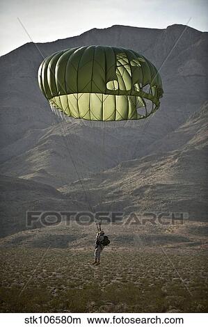 Soldier prepares to land after a static-line jump. View Large Photo Image Picture - Soldier prepares to land after a static-line jump.. Fotosearch