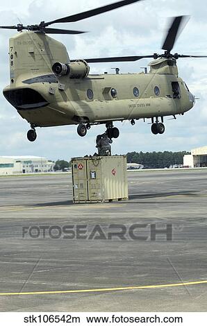 Soldiers attach a container to a CH-47F Chinook slingload hook. View Large Photo Image Picture - Soldiers attach a container to a CH-47F Chinook slingload hook.. Fotosearch