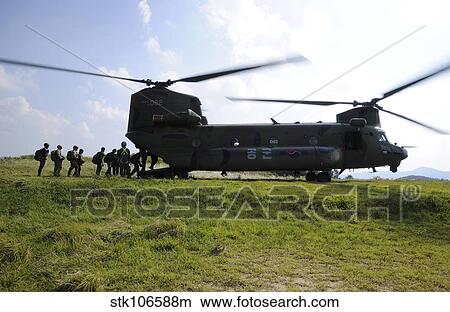Soldiers board a Republic of Korea Air Force CH-47 Chinook helicopter. View Large Photo Image Picture - Soldiers board a Republic of Korea Air Force CH-47 Chinook helicopter.. Fotosearch