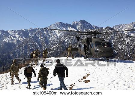 Soldiers board a U. S. Army UH-60 Black Hawk helicopter, Afghanistan. View Large Photo Image Picture - Soldiers board a U. S. Army UH-60 Black Hawk helicopter, Afghanistan.. Fotosearch