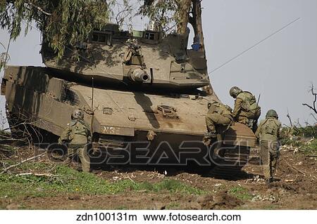 Soldiers climb into an Israel Defense Force Merkava Mark IV battle tank. View Large Photo Image Picture - Soldiers climb into an Israel Defense Force Merkava Mark IV battle tank.. Fotosearch