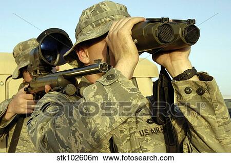 Picture - Soldiers demonstrate a buddy sniper position.. Fotosearch