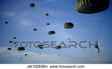 Soldiers descend under a parachute canopy during Operation Toy Drop. View Large Photo Image Picture - Soldiers descend under a parachute canopy during Operation Toy Drop.. Fotosearch