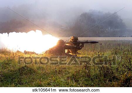 Soldiers fire a rocket propelled grenade at opposing forces. View Large Photo Image Picture - Soldiers fire a rocket propelled grenade at opposing forces.. Fotosearch