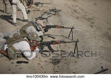 Soldiers fire a Russian RPK Kalashnikov Light Machine Gun. View Large Photo Image Picture - Soldiers fire a Russian RPK Kalashnikov Light Machine Gun.. Fotosearch