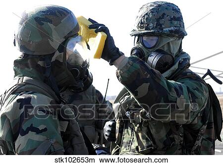Soldiers help each other during a decontamination process. View Large Photo Image Picture - Soldiers help each other during a decontamination process.. Fotosearch