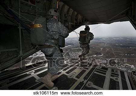 Soldiers jump from a C-130 aircraft over Germany. View Large Photo Image Picture - Soldiers jump from a C-130 aircraft over Germany.. Fotosearch
