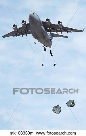Soldiers jump from a C-17 Globemaster III during a Mobility Air Forces Exercise. View Large Photo Image Picture - Soldiers jump from a C-17 Globemaster III during a Mobility Air Forces Exercise.. Fotosearch