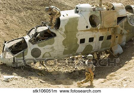Soldiers place TNT charges in the cockpit of a Polish Mi-24 helicopter. View Large Photo Image Picture - Soldiers place TNT charges in the cockpit of a Polish Mi-24 helicopter.. Fotosearch